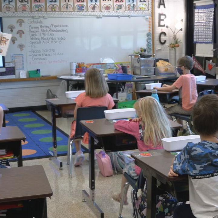 Masked teacher and students in class.jpeg